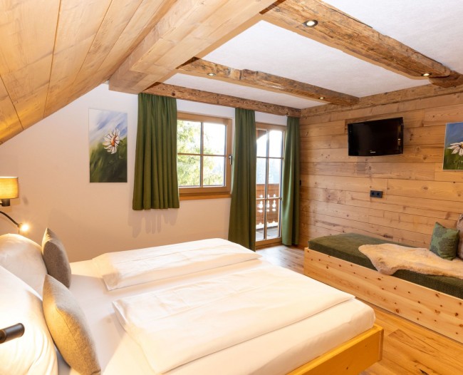 Schlafzimmer mit Einzelbett und Balkon